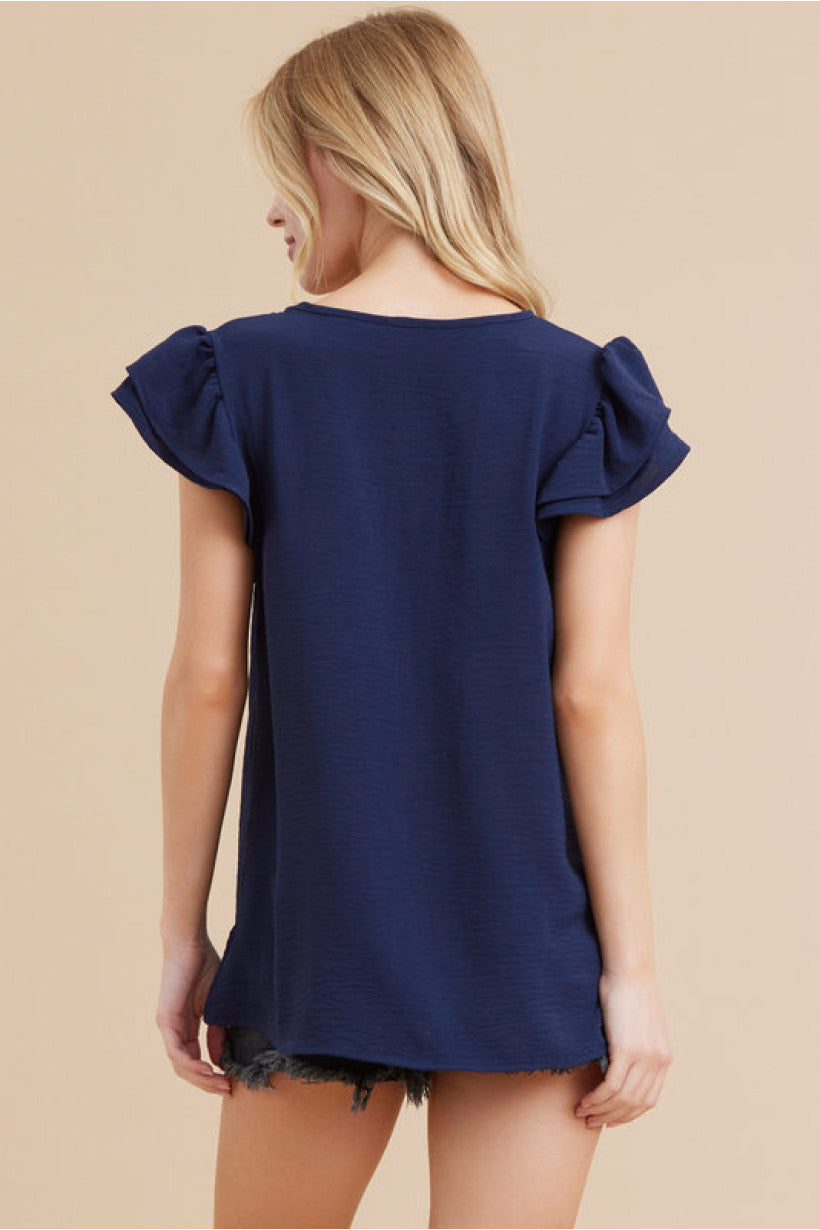 Solid Top V-Neckline and Ruffle Cap Sleeves.